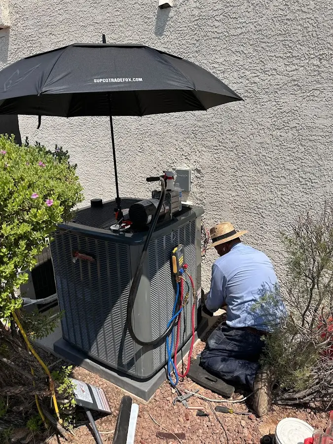 HVAC technician performing outdoor AC maintenance in Mashpee